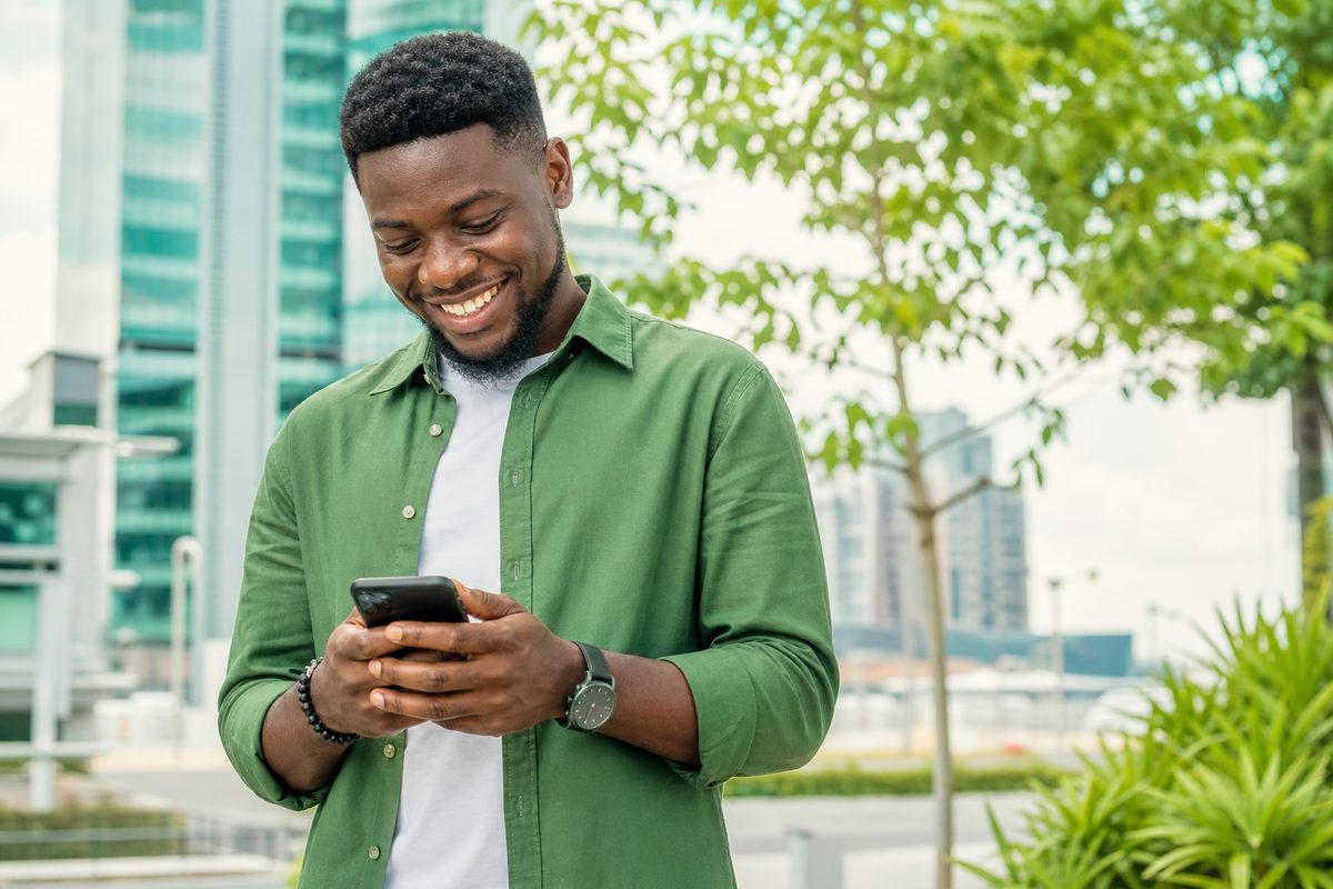 A happy PayTop customer topping up on a smartphone
